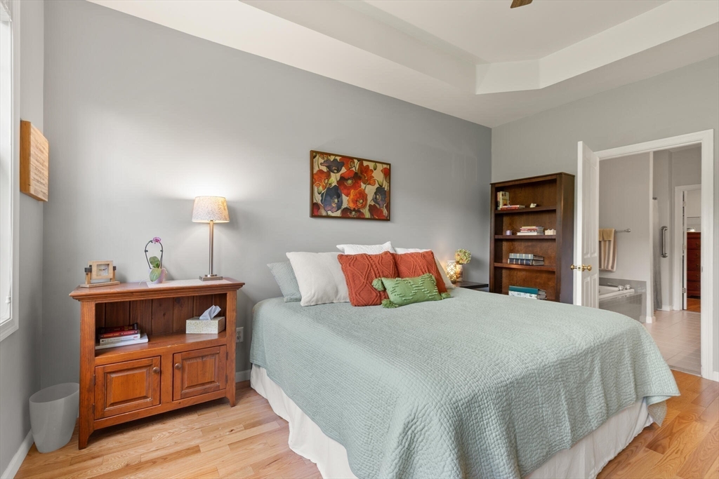 27 Brook Lane, Unit 27 Berlin, MA 01503 - Photo 20 of 36 a bedroom with a bed and a couch