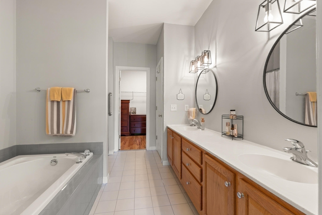 27 Brook Lane, Unit 27 Berlin, MA 01503 - Photo 21 of 36 a spacious bathroom with a tub sink and mirror