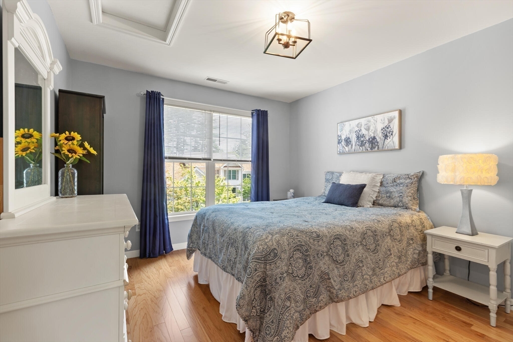 27 Brook Lane, Unit 27 Berlin, MA 01503 - Photo 27 of 36 a bedroom with a bed and a large window