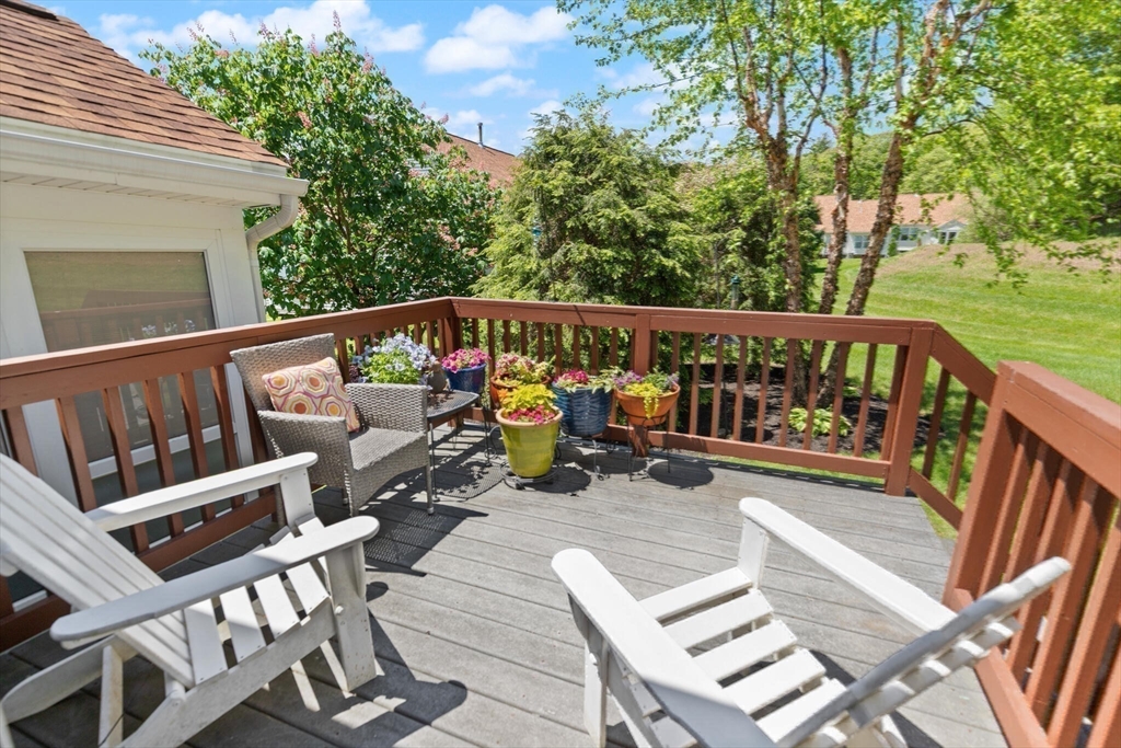 27 Brook Lane, Unit 27 Berlin, MA 01503 - Photo 29 of 36 a view of balcony with wooden floor and outdoor seating