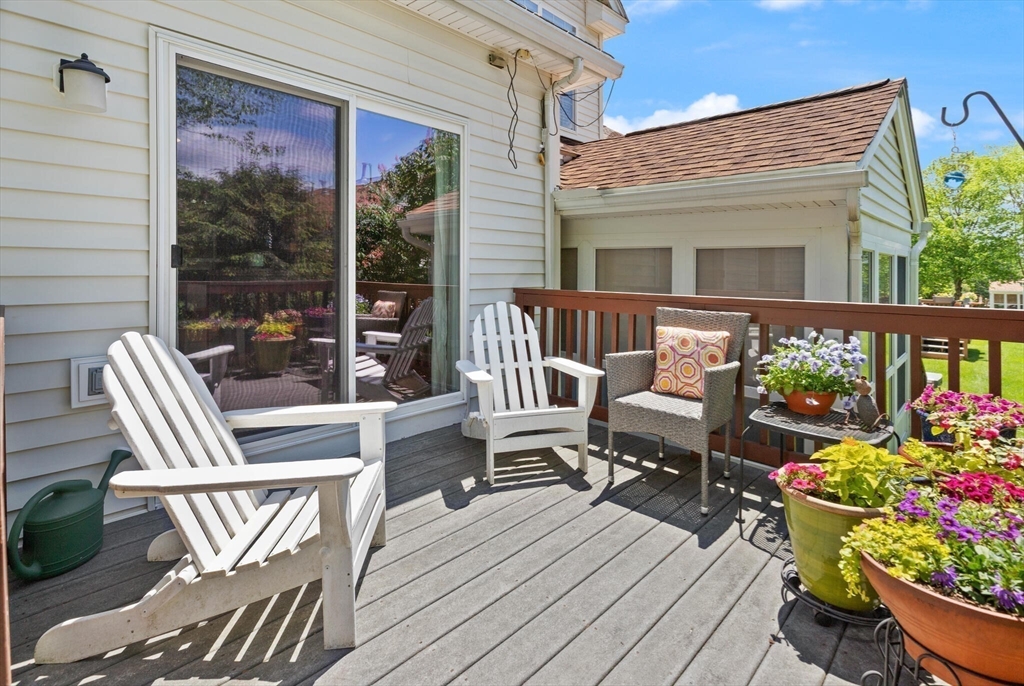 27 Brook Lane, Unit 27 Berlin, MA 01503 - Photo 30 of 36 a balcony with wooden floor and outdoor seating