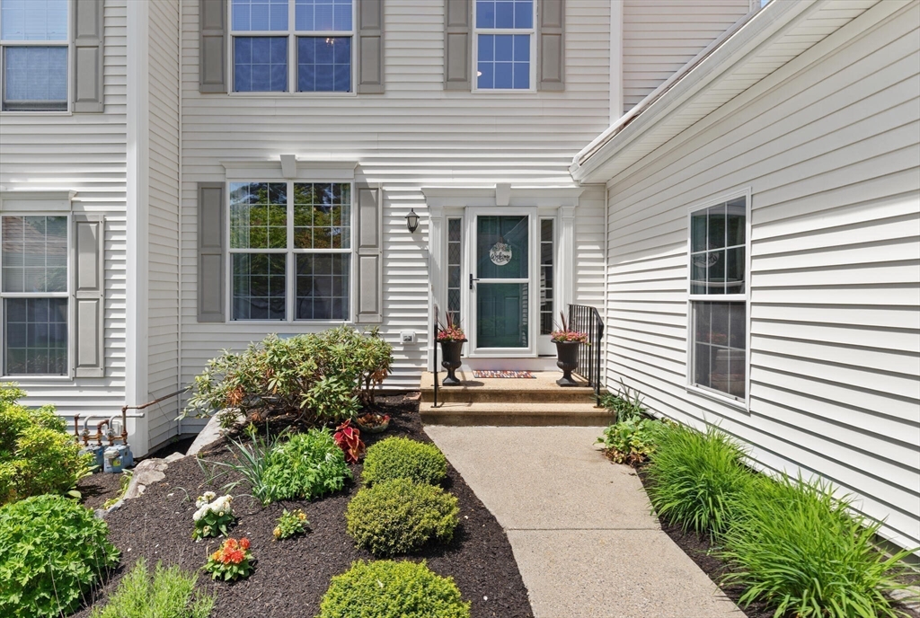 27 Brook Lane, Unit 27 Berlin, MA 01503 - Photo 3 of 36 a front view of a house with a yard