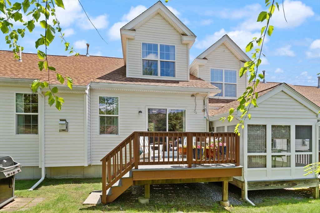 27 Brook Lane, Unit 27 Berlin, MA 01503 - Photo 31 of 36 front view of a house with a small yard