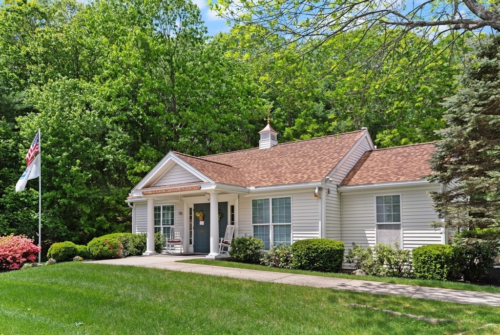 27 Brook Lane, Unit 27 Berlin, MA 01503 - Photo 34 of 36 a front view of a house with a yard and porch