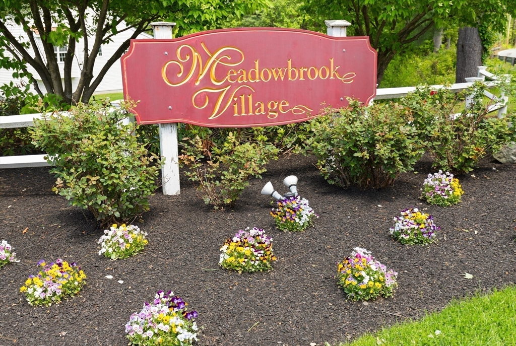 27 Brook Lane, Unit 27 Berlin, MA 01503 - Photo 35 of 36 a sign that is sitting in front of flowers