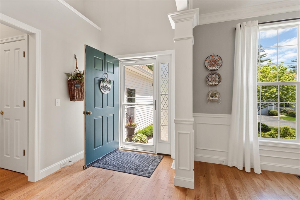 27 Brook Lane, Unit 27 Berlin, MA 01503 - Photo 5 of 36 a view of an entryway with wooden floor and a livingroom