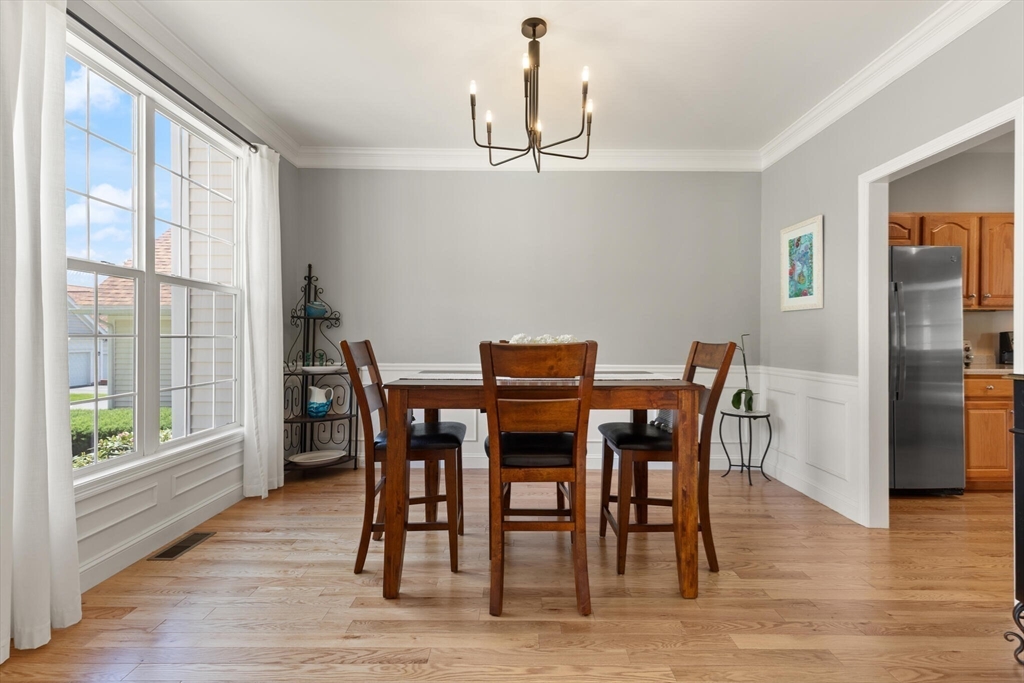 27 Brook Lane, Unit 27 Berlin, MA 01503 - Photo 7 of 36 a view of a dining room with furniture window and wooden floor