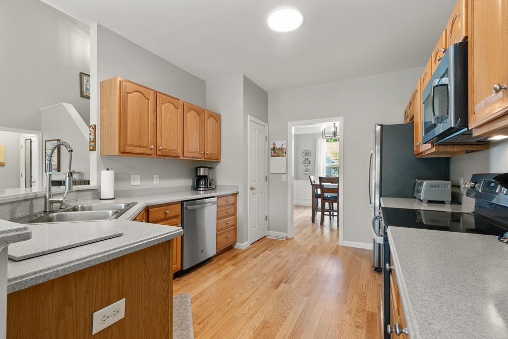 27 Brook Lane, Unit 27 Berlin, MA 01503 - Photo 10 of 36 a kitchen with stainless steel appliances granite countertop a sink stove and refrigerator