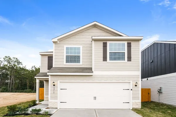 a front view of a house with garage