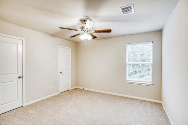 a view of an empty room with a window