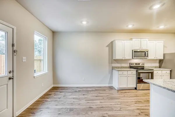 a kitchen with stainless steel appliances granite countertop a stove a sink and a refrigerator
