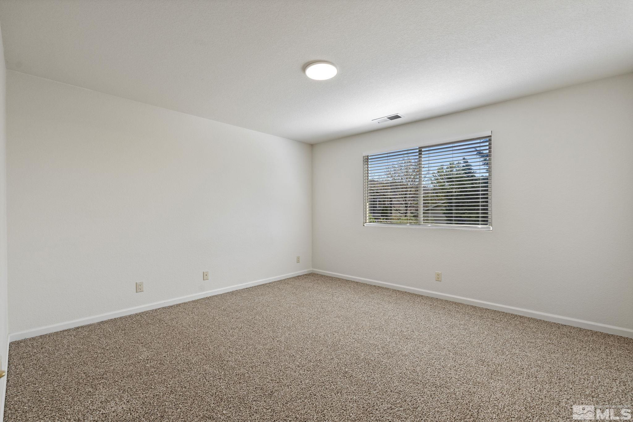 10015 Stonefield Drive Reno, NV 89521 - Photo 23 of 35 an empty room with a window