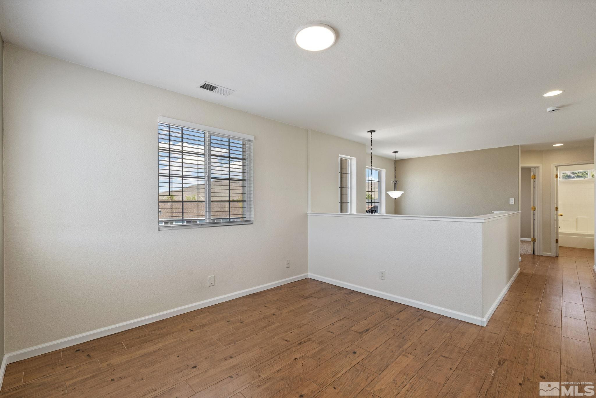 10015 Stonefield Drive Reno, NV 89521 - Photo 28 of 35 wooden floor in an empty room with a window