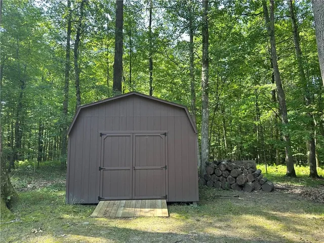 a view of a patio with table and chairs potted plants with floor to ceiling window