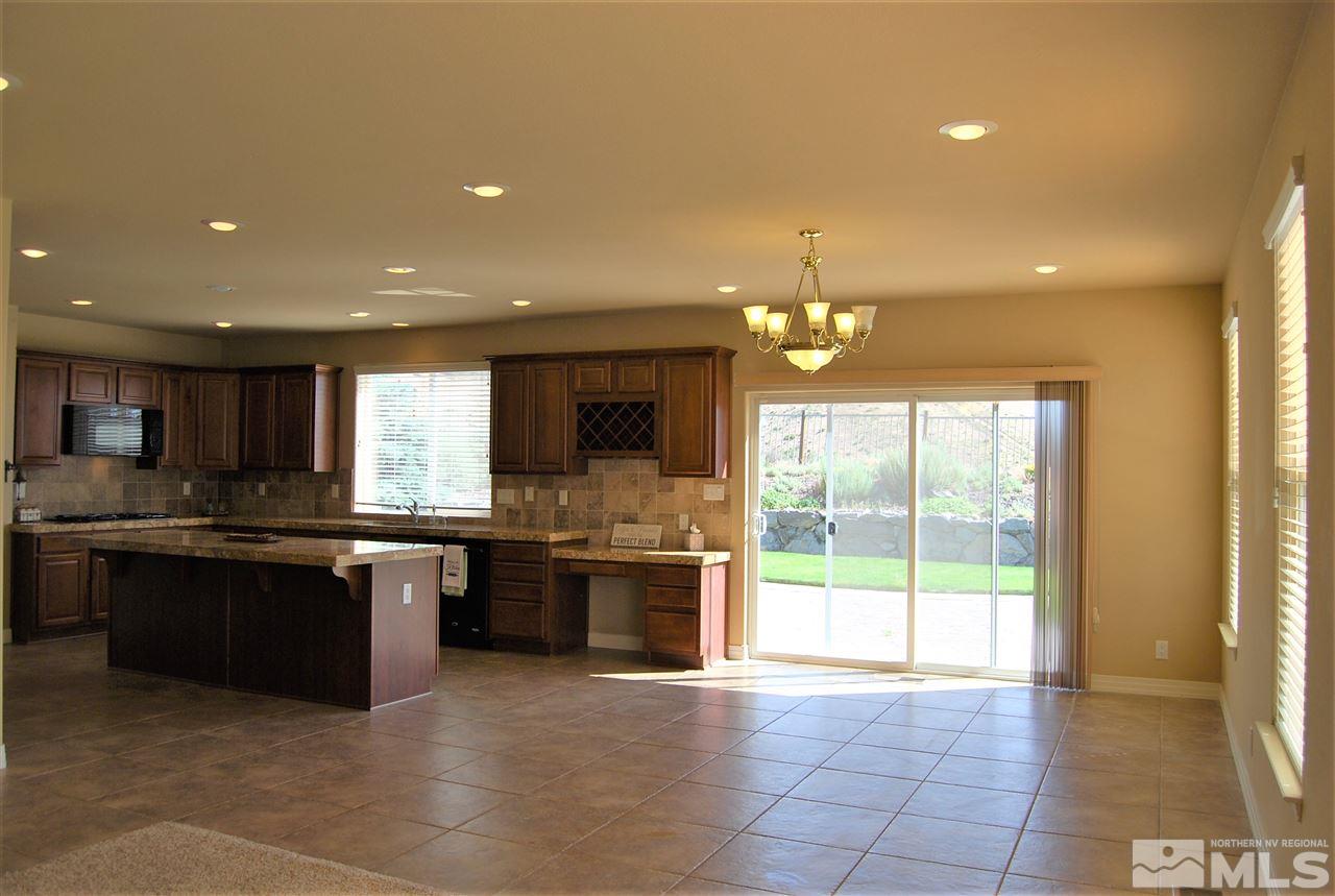 2900 Sandestin Drive Reno, NV 89523 - Photo 13 of 24 a large kitchen with granite countertop a large stove top oven and cabinets