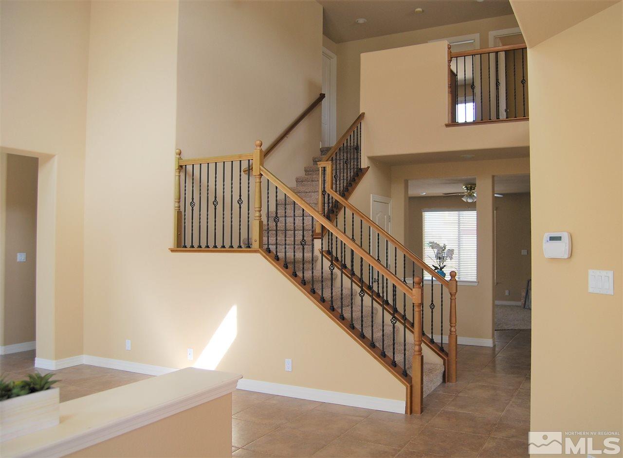 2900 Sandestin Drive Reno, NV 89523 - Photo 8 of 24 a view of staircase with lots of frames on wall and a window