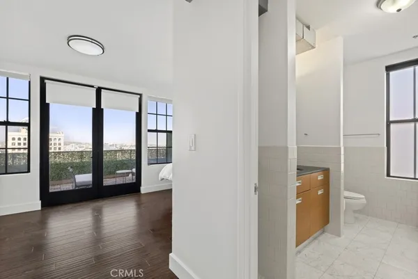 a large white bed sitting in a room next to a window