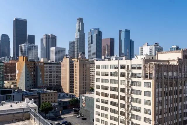 a view of swimming pool with outdoor seating and city view