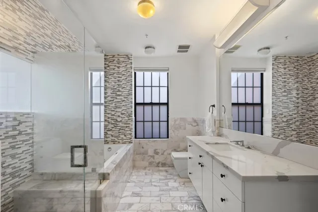 a bedroom with a bed and a window with wooden floor