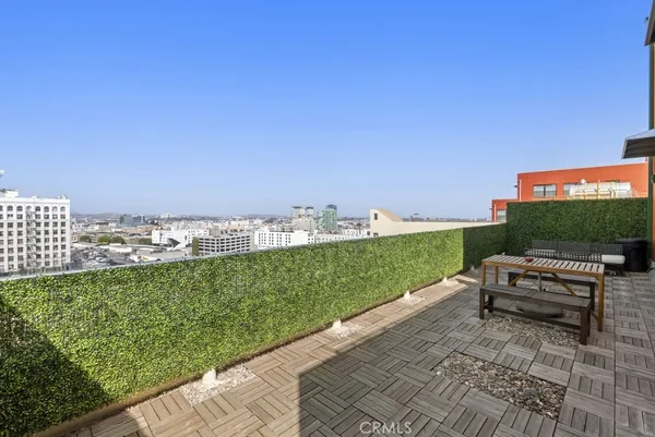 a backyard of a house with barbeque oven table and chairs