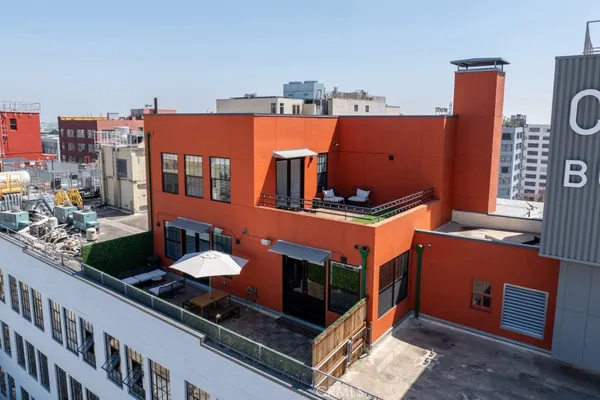 an aerial view of a balcony with chairs