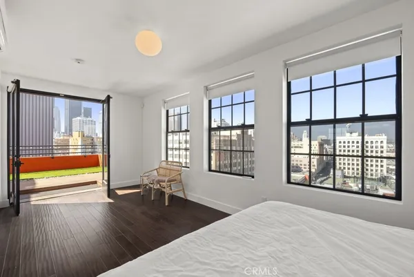 a view of a room with wooden floor and windows