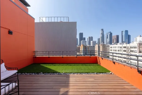 a view of swimming pool with outdoor seating and city view