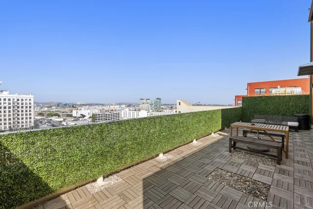 a view of a city from a patio with chairs