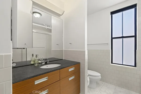 a large white bed sitting in a room next to a window