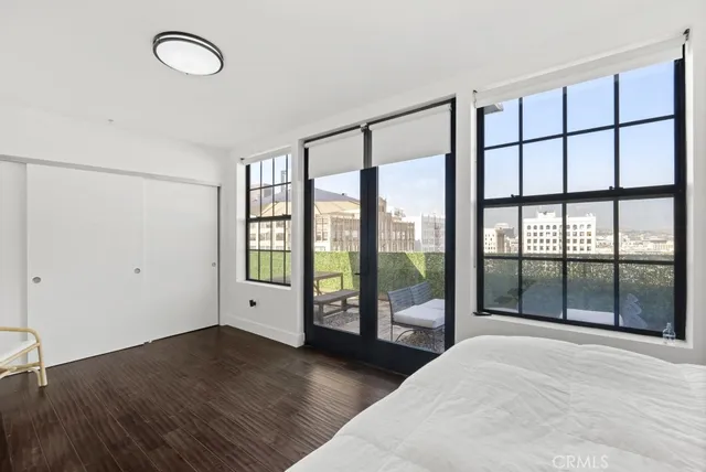a large white bed sitting in a room next to a window