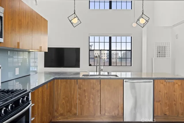 a kitchen with granite countertop stainless steel appliances and wooden cabinets