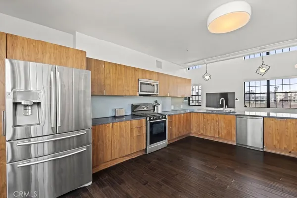 a kitchen with stainless steel appliances a stove top oven