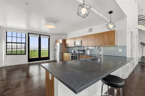 a kitchen with stainless steel appliances a stove top oven