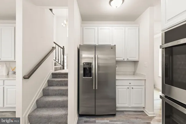 a kitchen with cabinets and stainless steel appliances
