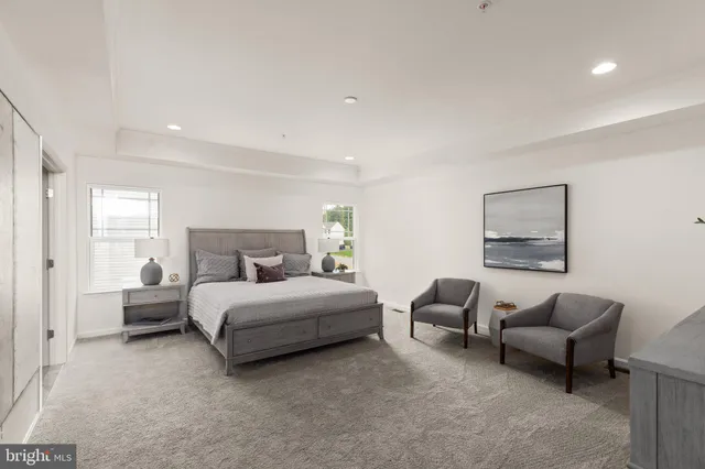 a spacious bedroom with a bed and a couch