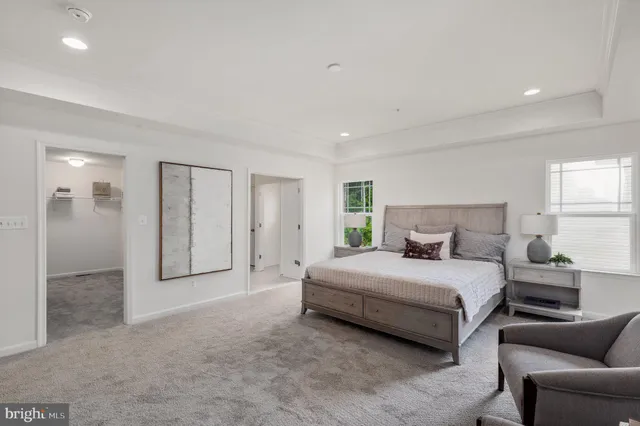 a bedroom with a bed couch and window