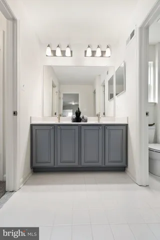 a bathroom with a double vanity sink and mirror