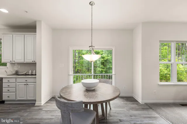 a kitchen with a table and a potted plant