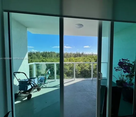 a view of a balcony with chairs and a table