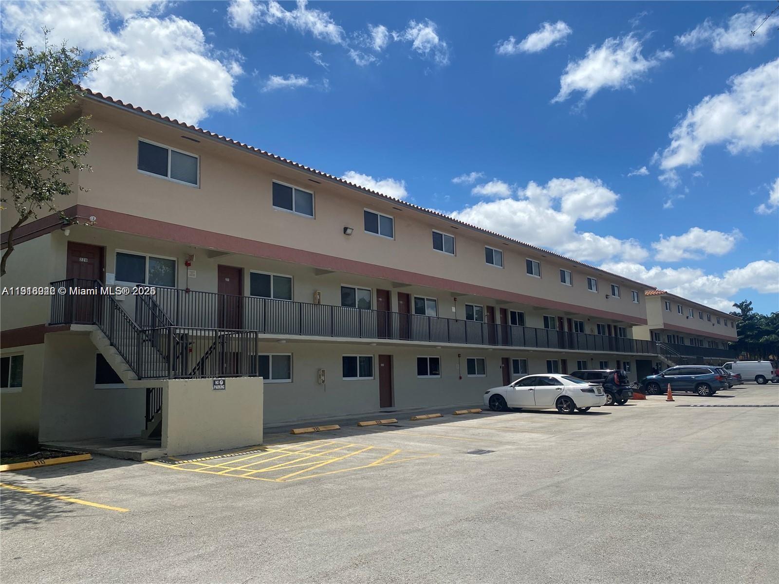 1650 West 44th Place, Unit 227 Hialeah, FL 33012 - Photo 1 of 9 a view of building with car parked