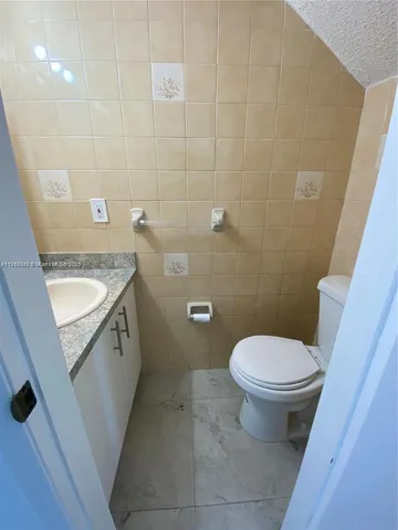 a bathroom with a sink a toilet and a shower