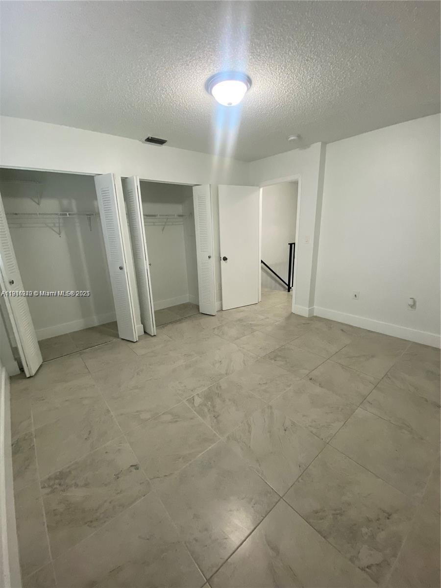 1650 West 44th Place, Unit 227 Hialeah, FL 33012 - Photo 5 of 9 an empty room with a natural light