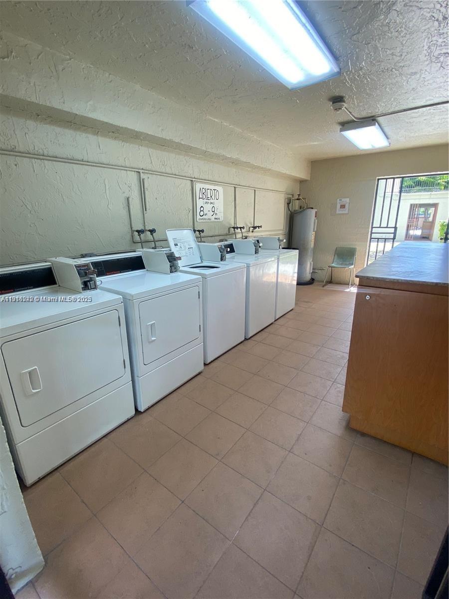 1650 West 44th Place, Unit 227 Hialeah, FL 33012 - Photo 8 of 9 a room with a bed and a couch