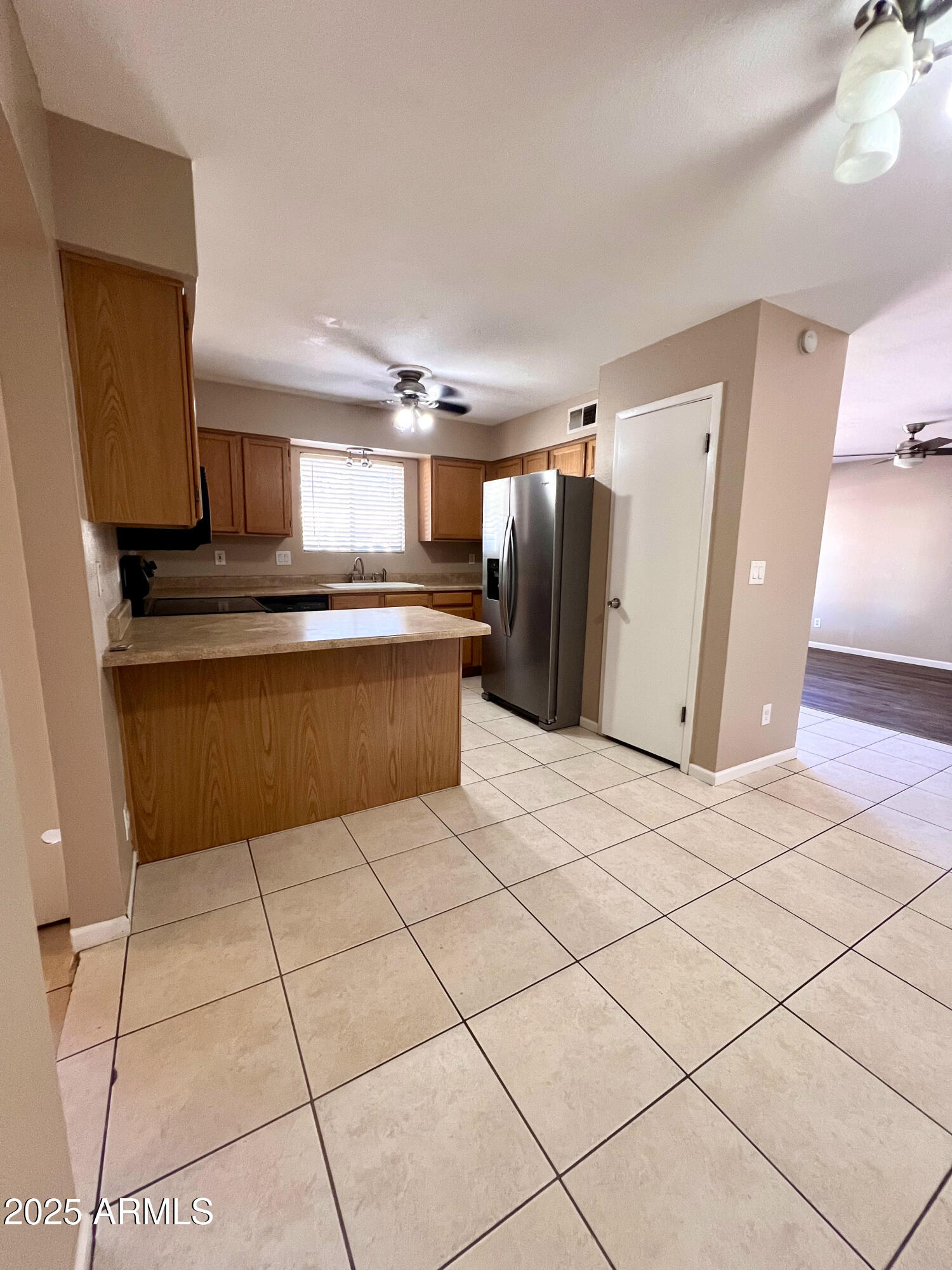121 East Olive Avenue Gilbert, AZ 85234 - Photo 11 of 25 a kitchen with stainless steel appliances granite countertop a refrigerator and a stove top oven