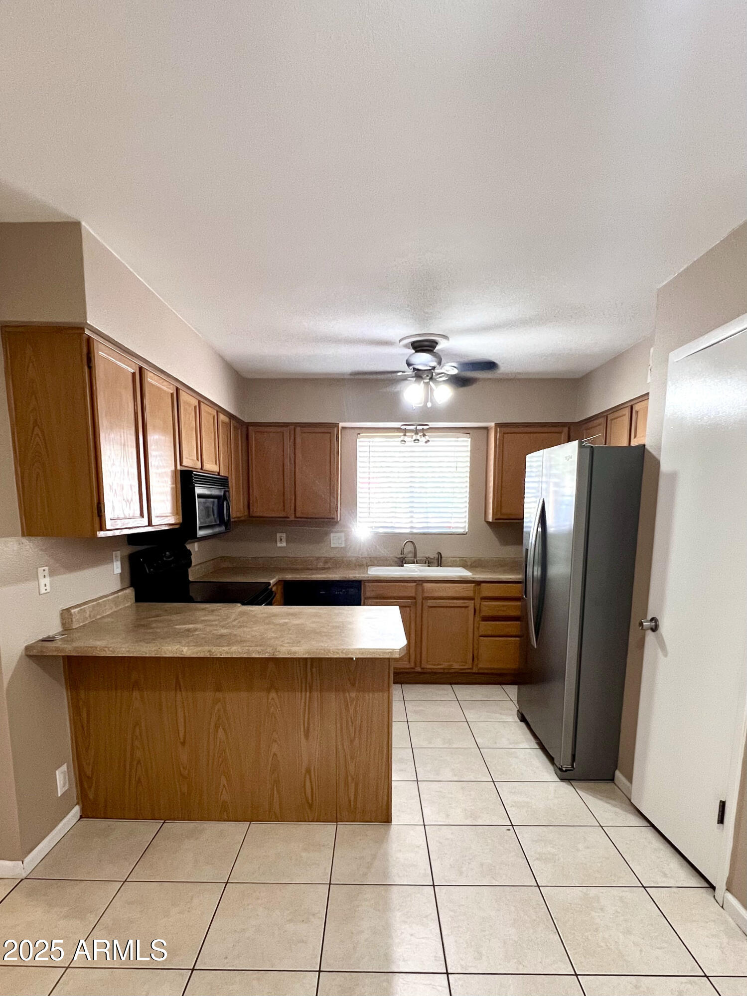 121 East Olive Avenue Gilbert, AZ 85234 - Photo 12 of 25 a large kitchen with granite countertop a stove a sink dishwasher and a refrigerator with wooden cabinets