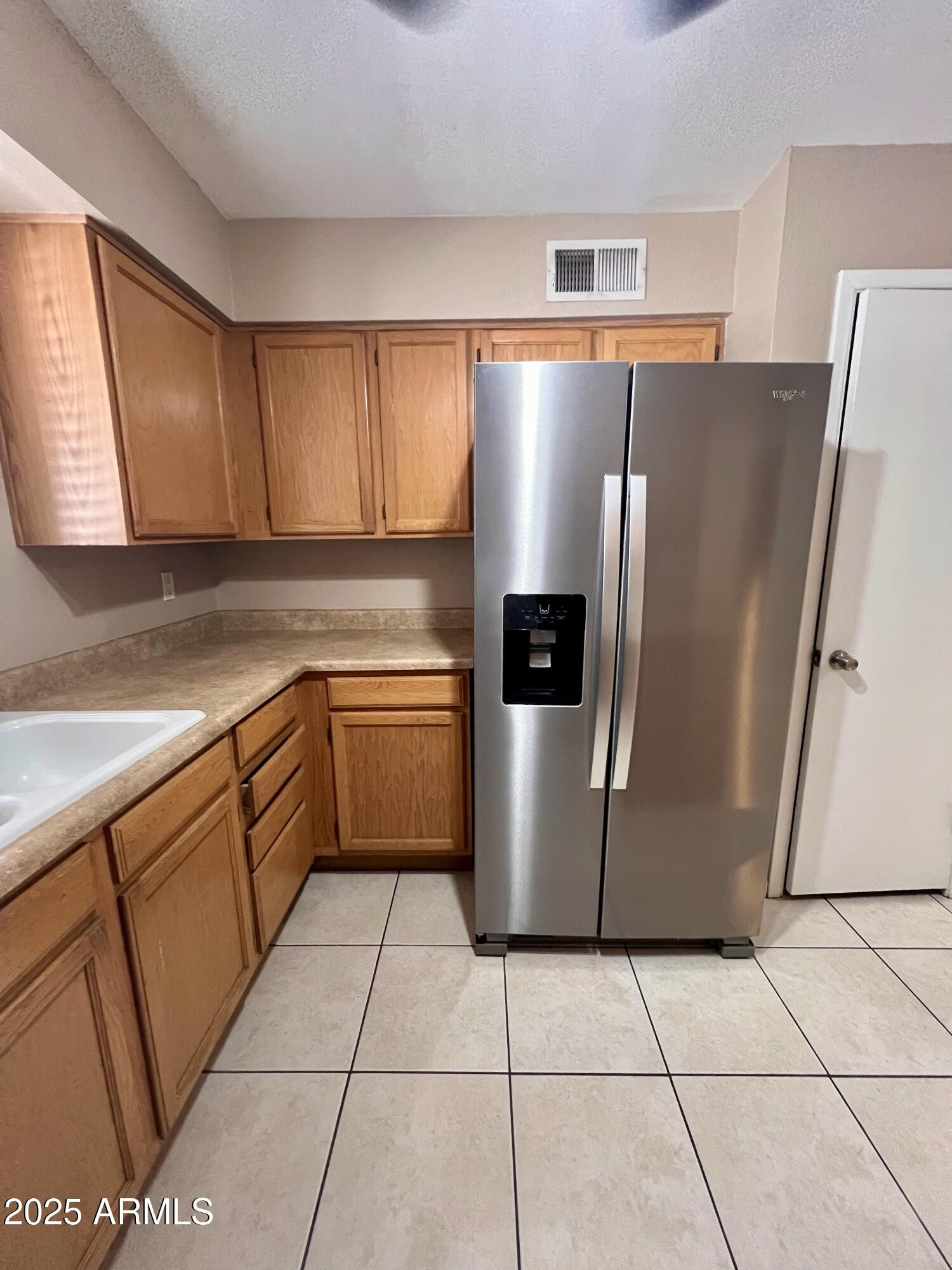121 East Olive Avenue Gilbert, AZ 85234 - Photo 13 of 25 a kitchen with a refrigerator sink and cabinets