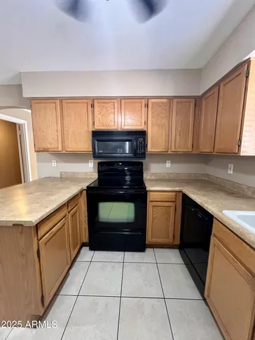 a kitchen with a stove top oven and cabinets