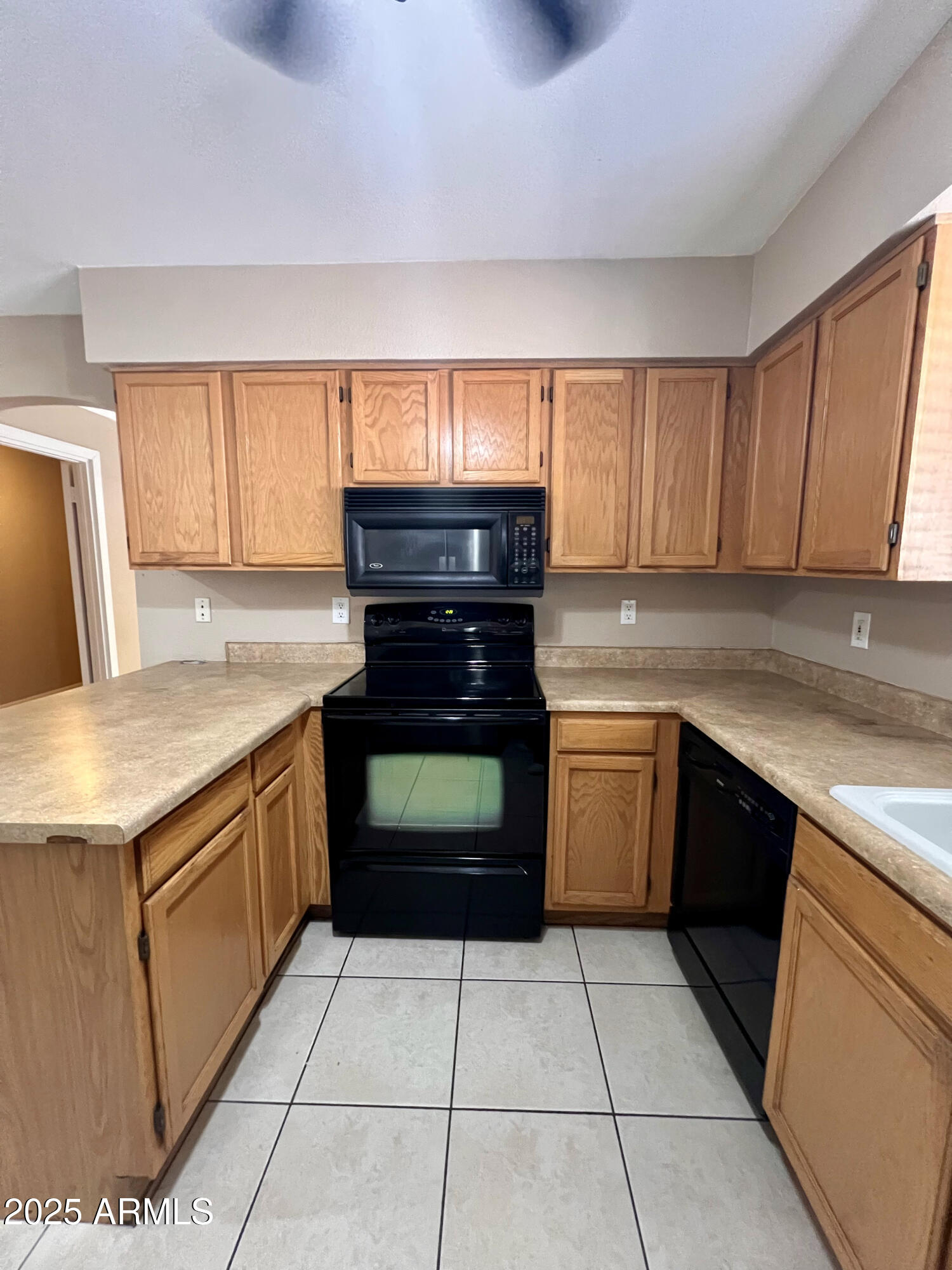 121 East Olive Avenue Gilbert, AZ 85234 - Photo 14 of 25 a kitchen with a stove top oven and cabinets