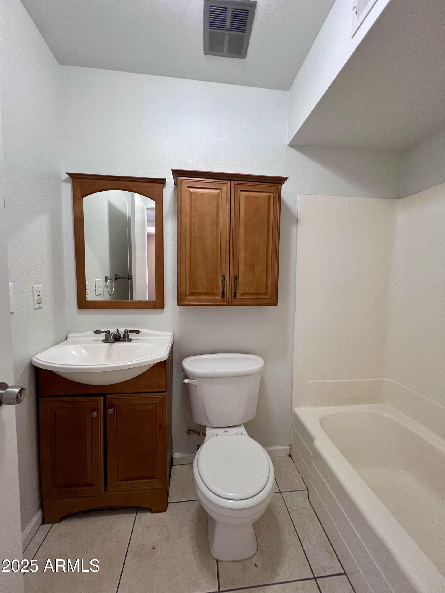 121 East Olive Avenue Gilbert, AZ 85234 - Photo 19 of 25 a bathroom with a sink and mirror with toilet
