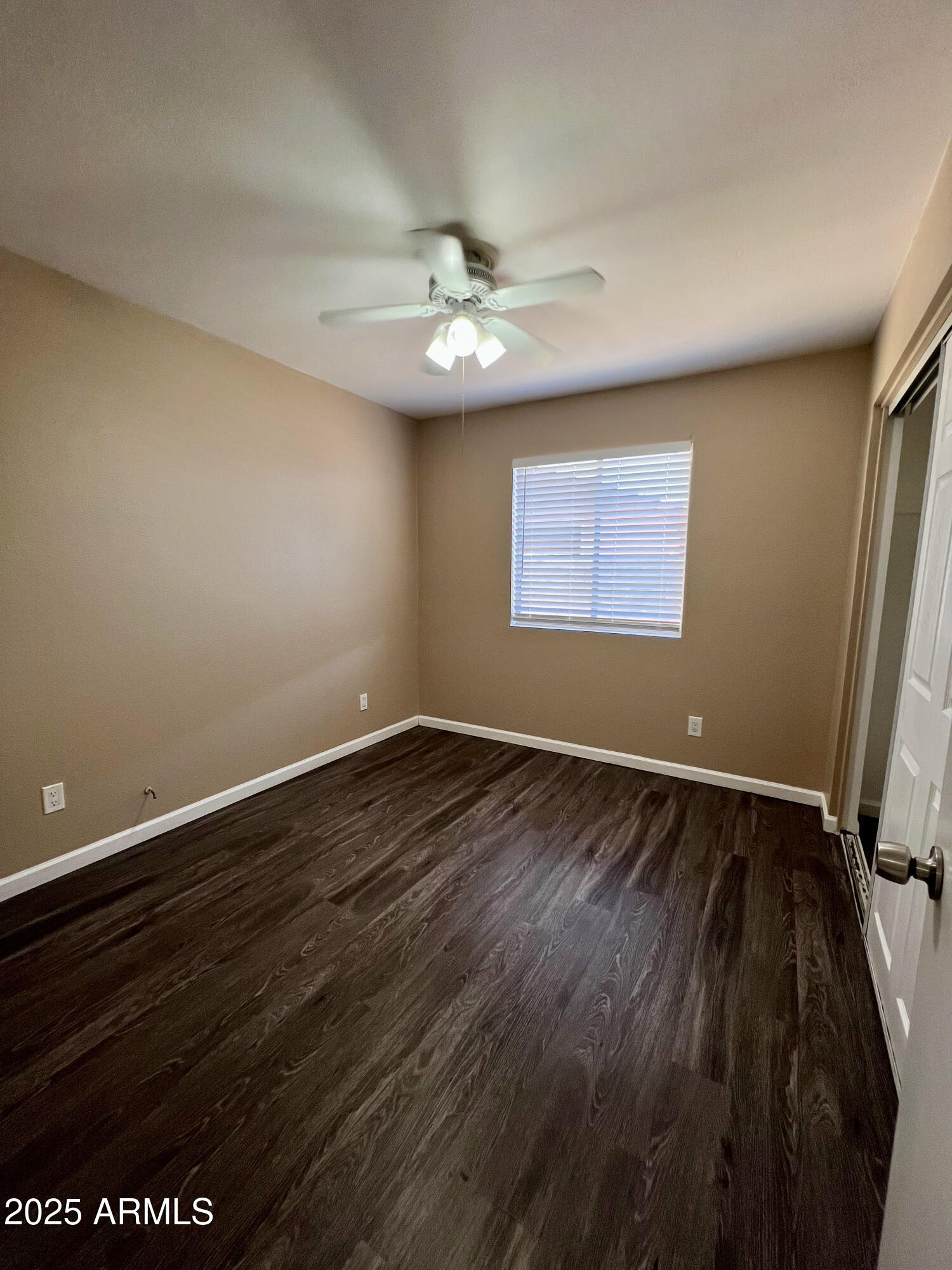121 East Olive Avenue Gilbert, AZ 85234 - Photo 20 of 25 an empty room with wooden floor and windows